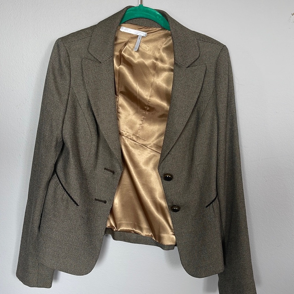 A business suit and brown color and gently used without any pockets .